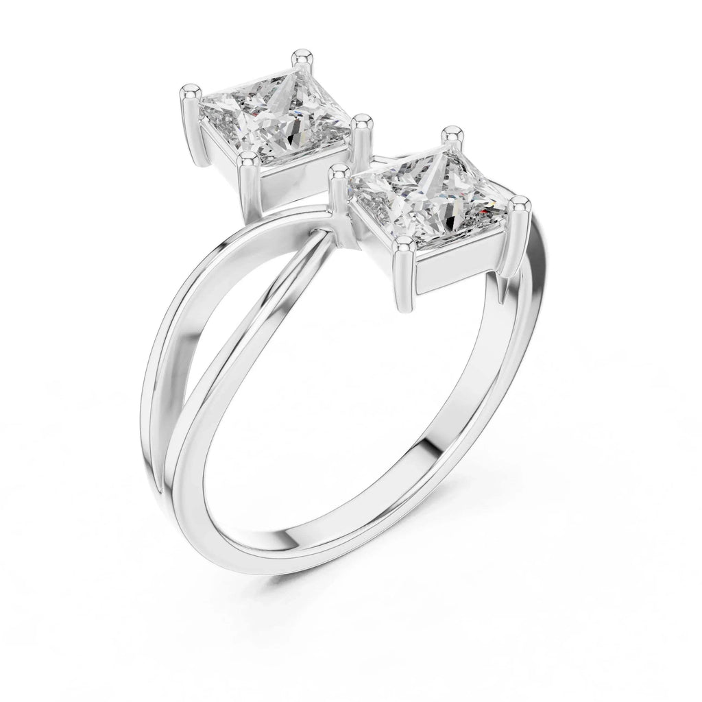 White gold ring with two princess-cut real diamonds on a white background