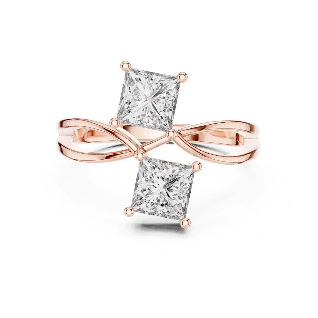 Rose gold ring with two princess-cut real diamonds on a white background
