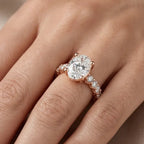 Rose gold ring with a large oval shape real diamond and small round shape real diamonds on a hand