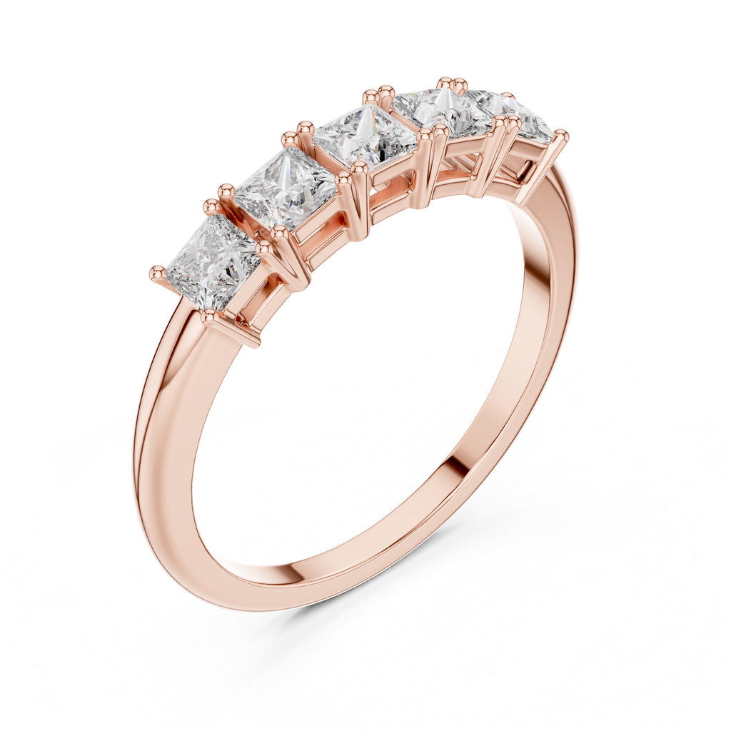 Rose gold ring with diamond stones on a white background