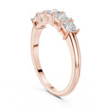 Rose gold ring with clear diamonds on a white background