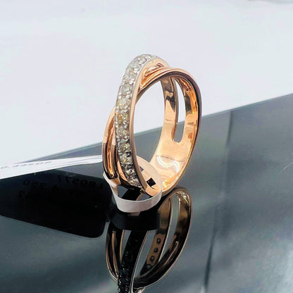 A diamond band ring with 14K gold hallmark, displayed on black reflective surface.