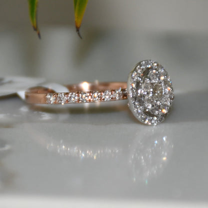 A diamond ring is displayed on a reflective surface.