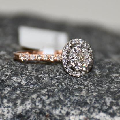 A diamond ring is displayed on a rough and textured surface.