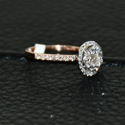 A diamond ring is displayed on a black leathered surface.