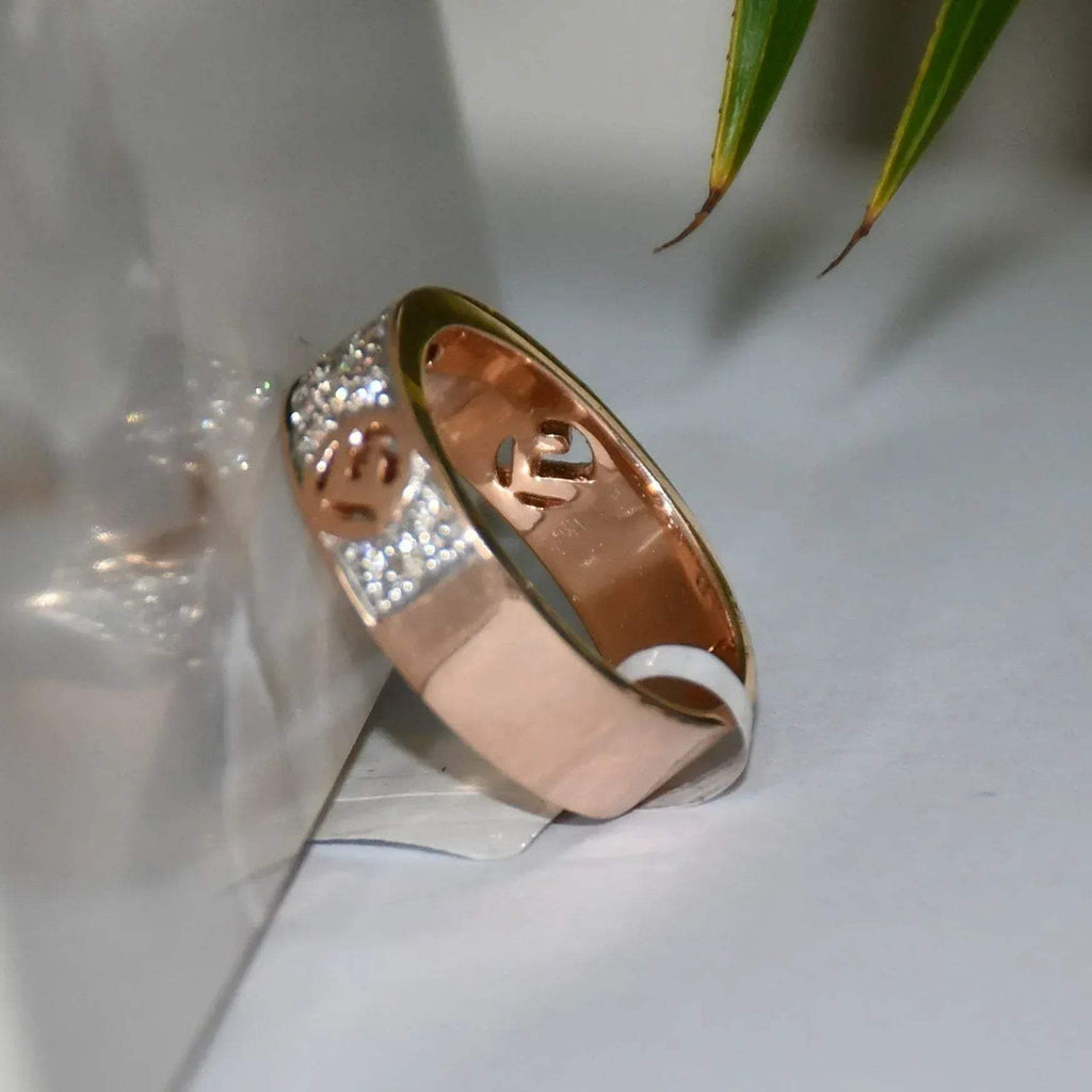 A 14kt gold diamond band ring with smaller diamonds, set on a gold band displayed on a white surface against a reflective surface.