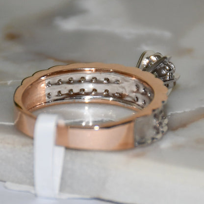 A 14K gold diamond band ring with a clear, certified diamond centerpiece displayed on a white smooth surface.