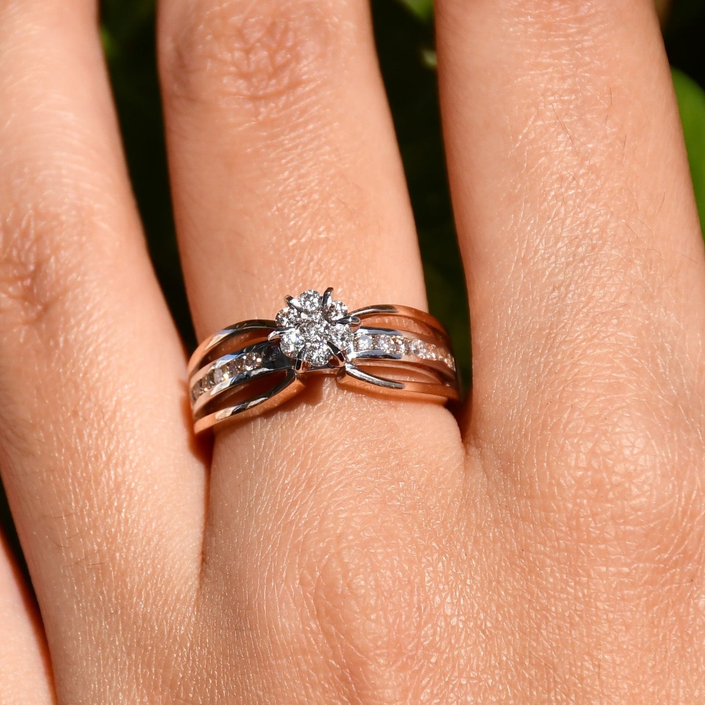 A diamond band ring with 14K gold hallmark, displayed in a hand's middle finger.