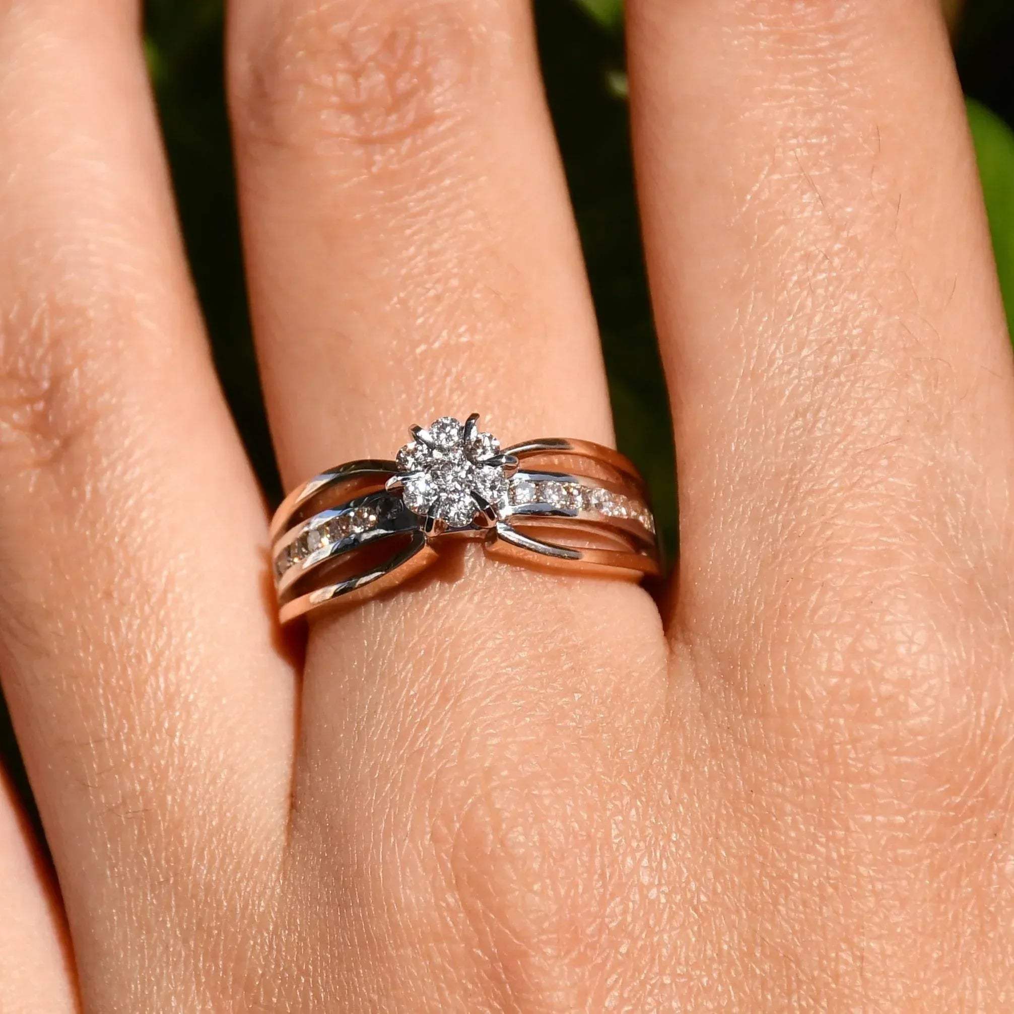 A diamond band ring with 14K gold hallmark, displayed in a hand's middle finger.