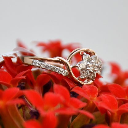 A 14kt gold diamond band ring with brilliant cut natural diamonds on red flowers.