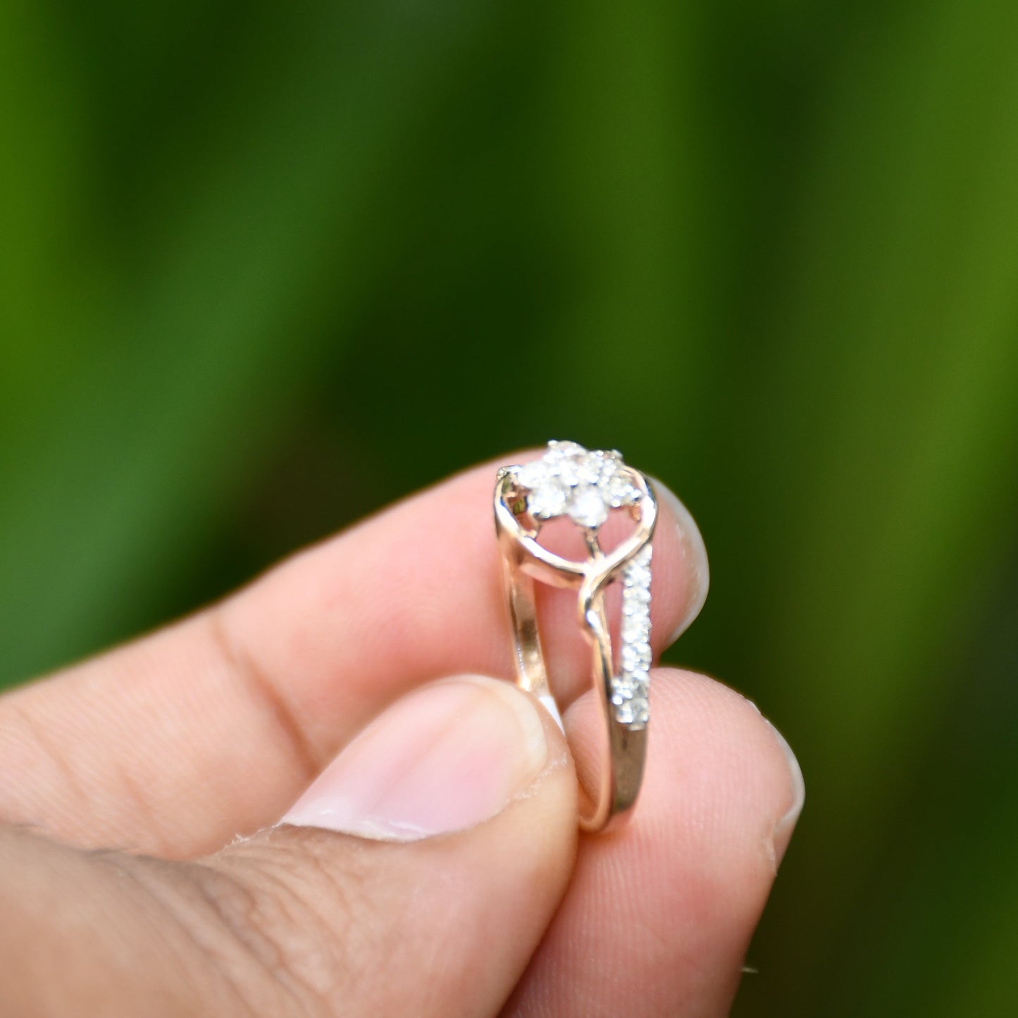 A 14kt gold diamond band ring with brilliant cut natural diamonds displayed holding by hands.