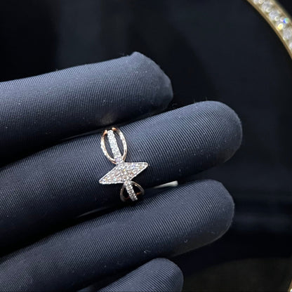 A handcrafted natural diamond solid gold ring, held in a gloved hand, featuring a brilliant cut diamond on a band with a star-shaped detail on the top.
