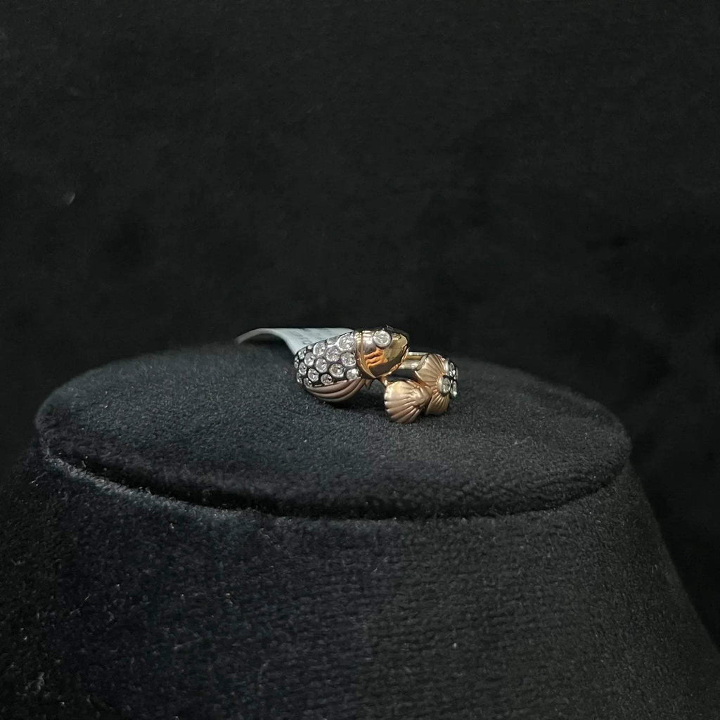 A ring with a gold band and a central natural diamonds, displayed on black mannequin bust.