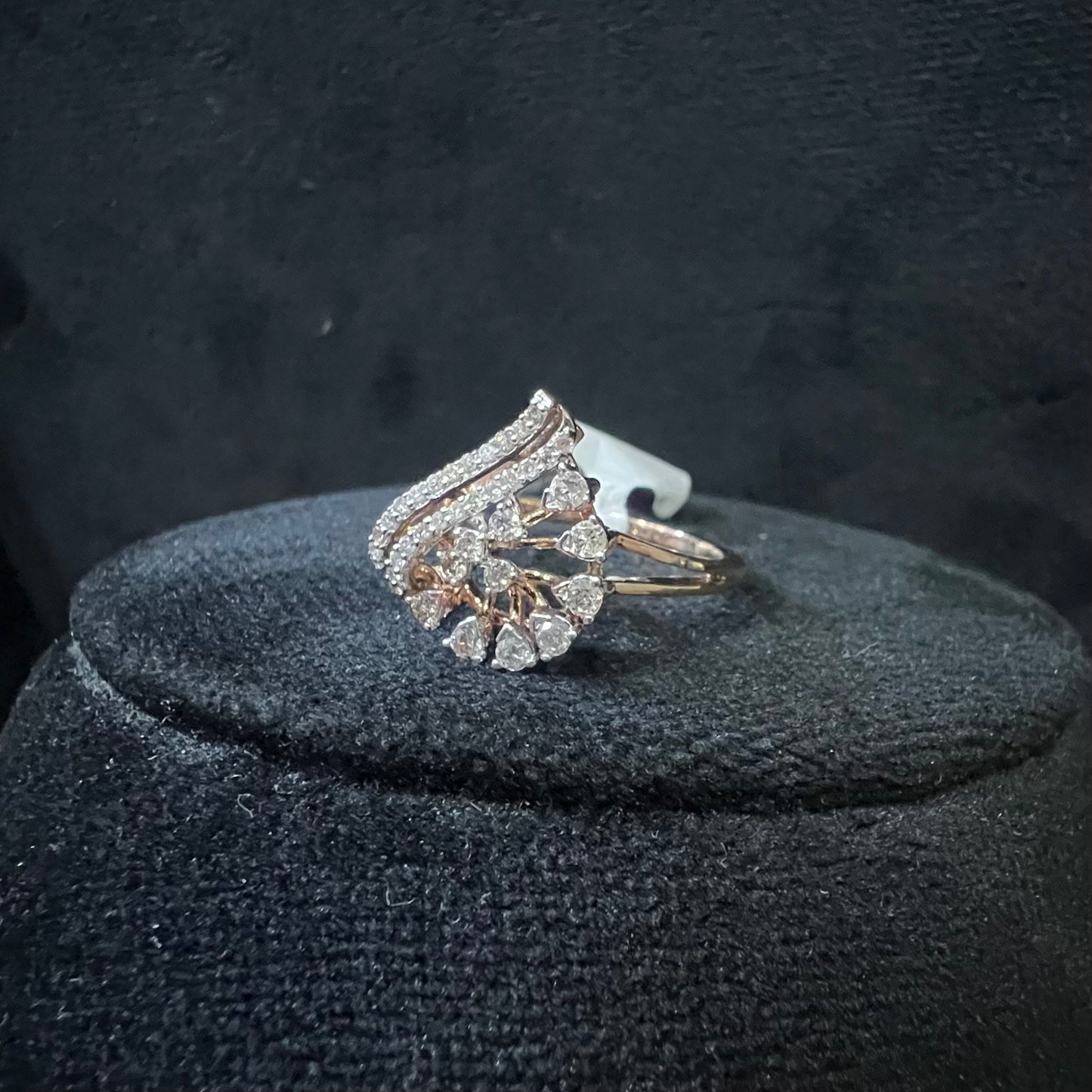 A handcrafted natural diamond solid gold ring displayed on a mannequin bust, with a brilliant cut diamond in a gold band.