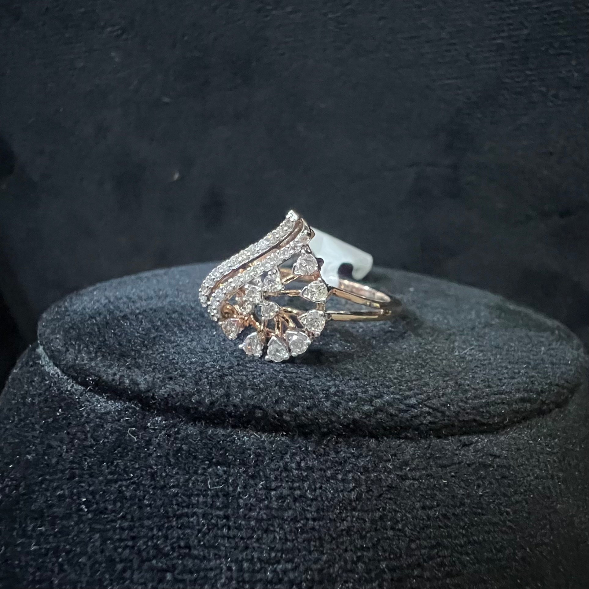 A handcrafted natural diamond solid gold ring displayed on a mannequin bust, with a brilliant cut diamond in a gold band.