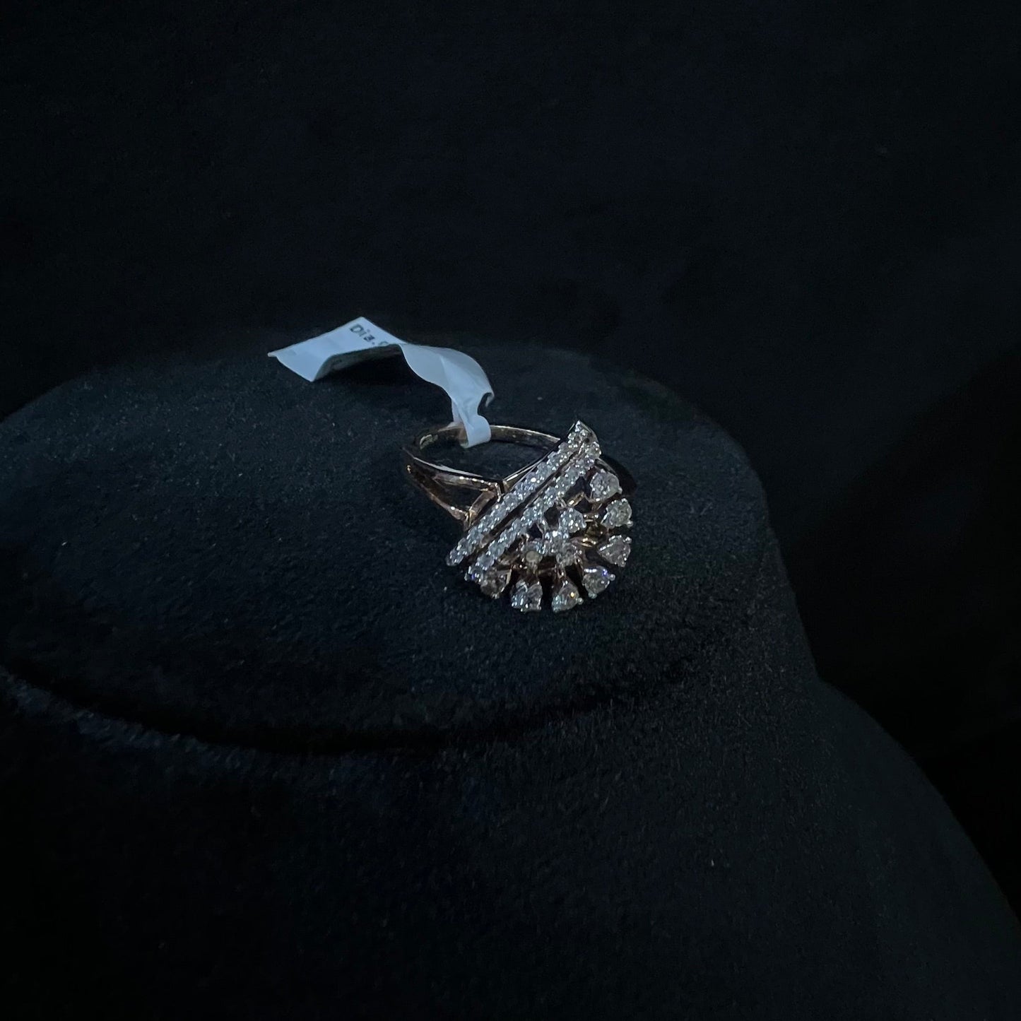 A handcrafted natural diamond solid gold ring displayed on a mannequin bust, with a brilliant cut diamond in a gold band.