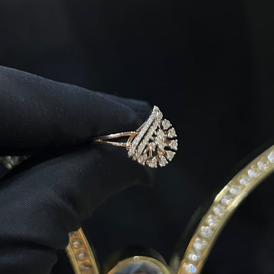 A handcrafted natural diamond solid gold ring held by a hand, with a brilliant cut diamond in a gold band.