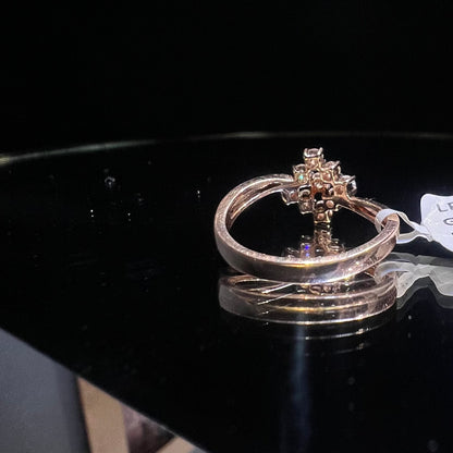 A handcrafted natural diamond solid gold ring, held on a reflective surface, showcasing the ring's design and the shine of the diamonds.