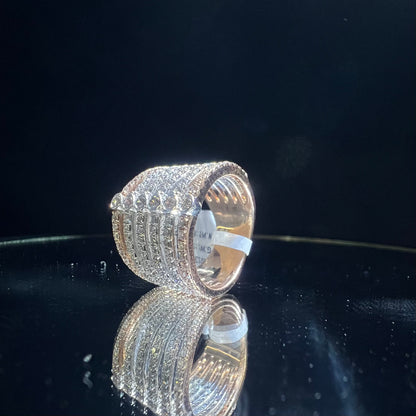Close-up of a modern multi-band diamond ring featuring parallel pavé-set rows connected by bezel-set round diamonds, crafted in gold and reflecting light beautifully, displayed on a reflective surface.