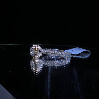 A a solitaire diamond band ring, displayed on a reflective surface.