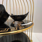 Close-up of an elegant wide diamond ring, featuring multiple crisscrossing bands adorned with round-cut diamonds set in gold, displayed on a black reflective surface.